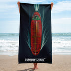 Person holding a beach towel with a red green Tanker Ship on teh beach