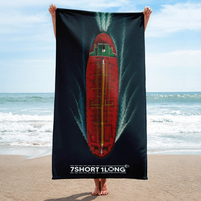 Person holding a beach towel with a red green Tanker Ship on teh beach Hover Image