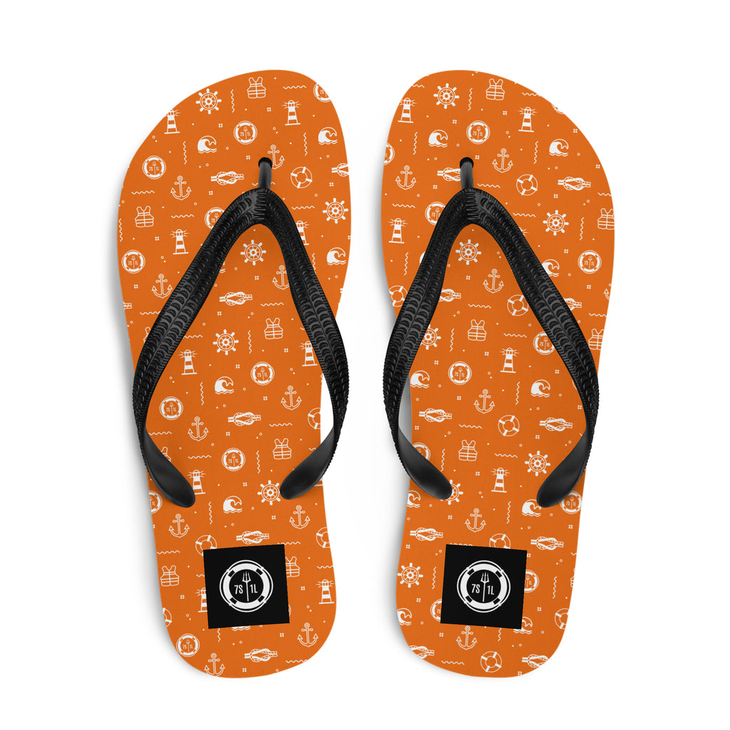 Orange flip-flops with black straps and white maritime pattern on a white background